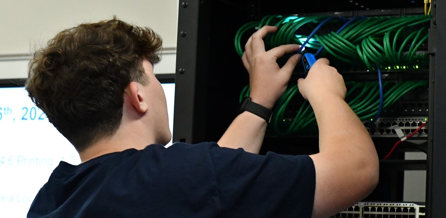 Cybersecurity student checking wires