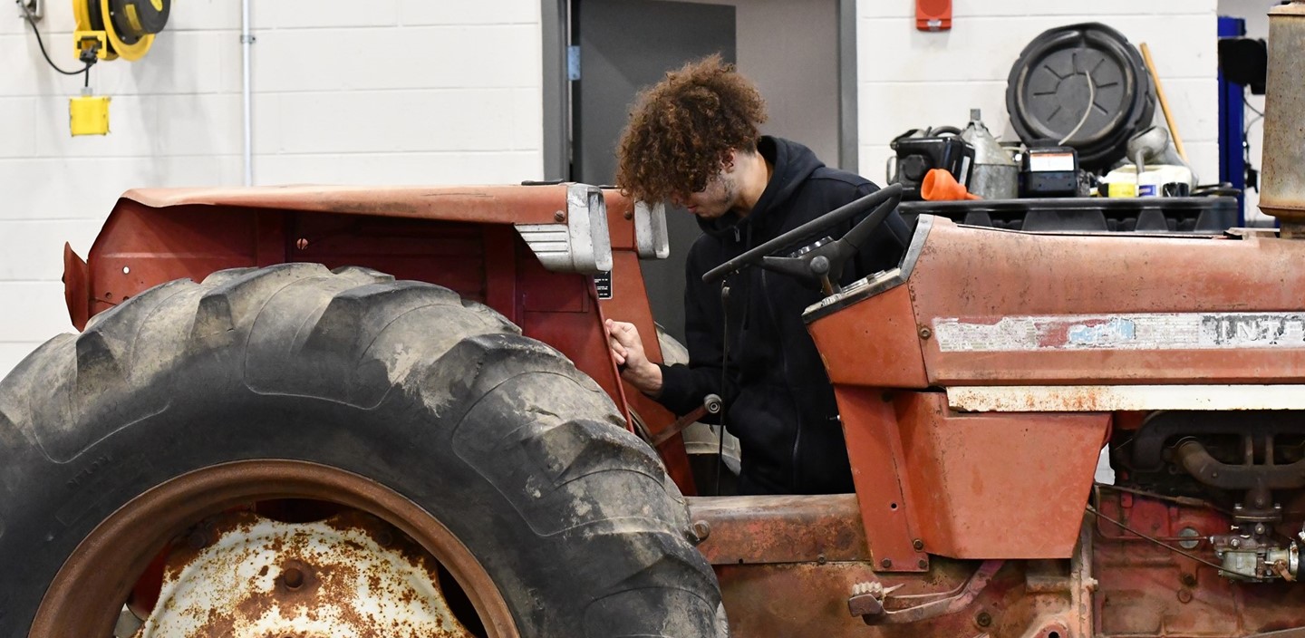Power Equipment Student working on tractor